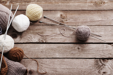 Knitting and knitting needles on a wooden surface