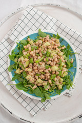 Salad with spinach, arugula, avocado, sprouted seeds and beans