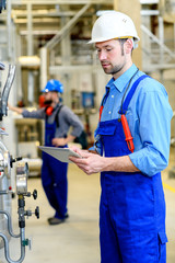 two worker with helmet ,ear protector and goggles