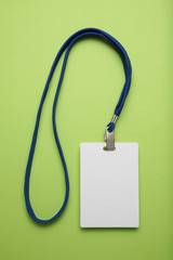 Security badge, lanyard plastic clip, template on green background.