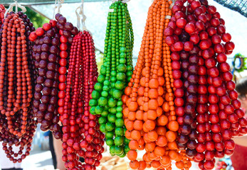 Sale of beautiful colorful women's jewelry made of wooden beads. Fair - an exhibition of folk craftsmen.
