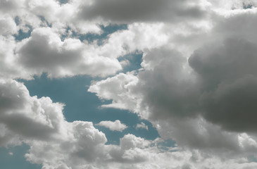 Puffy white clouds against a clean and bright blue sky.