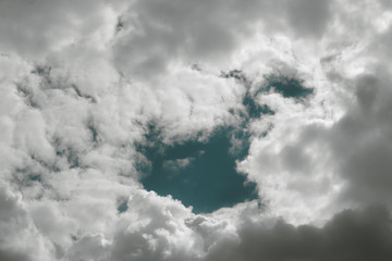 Puffy white clouds against a clean and bright blue sky.