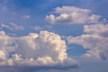 Light cumulus clouds in the blue sky.
