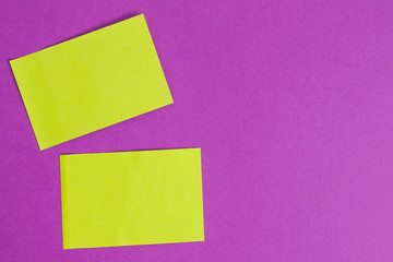 Obraz na płótnie Canvas Two green stickers on a purple background.
