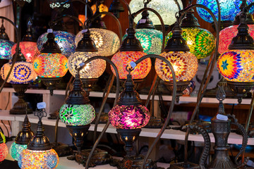 Rows of stained glass hanging lamps for sale at the handicraft market