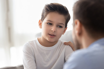 Caring dad talk with little son showing love and support