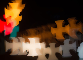 Bokeh background pattern in the shape of a cross