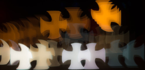 Bokeh background pattern in the shape of a cross