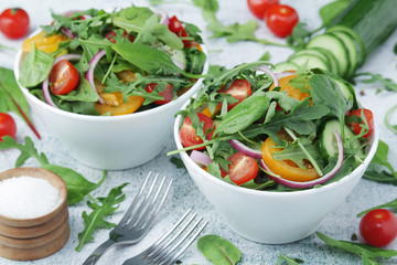 Two bowls full of vegetable salad