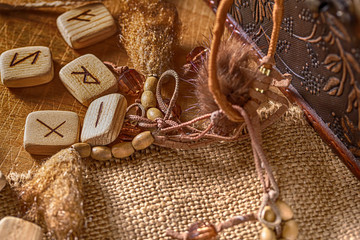 Handmade scandinavian wooden runes on a wooden vintage background. Concept of fortune telling and prediction of the future.