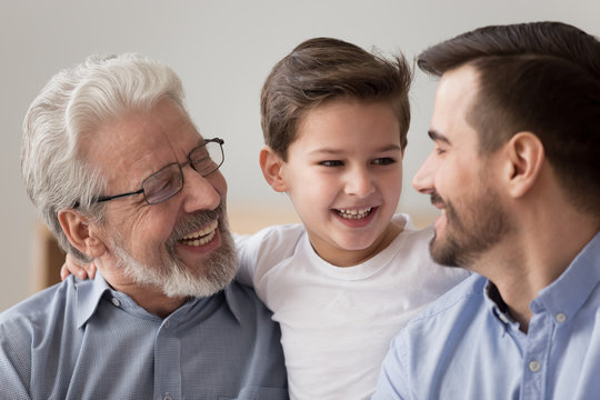 Close up of happy three generations of men have fun