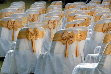 Gold ribbon on chair set in a wedding celebration