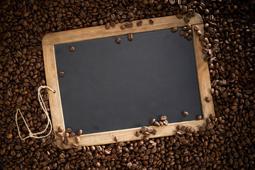 Vintage school slate surrounded by coffee beans