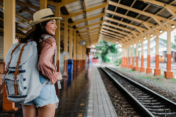 woman  backpacker traveler with backpack at train station. journey trip travel concept