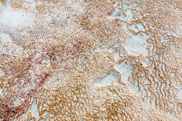 White limestones in Pamukkale. Calcium deposits from thermal springs. The texture of the stone.