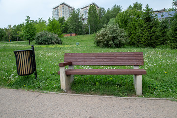 Wooden bench with a urn in the park.