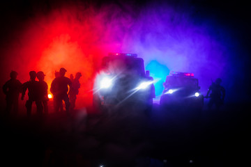Police cars at night. Police car chasing a car at night with fog background. 911 Emergency response pSelective focus