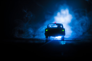 Fototapeta na wymiar Police cars at night. Police car chasing a car at night with fog background. 911 Emergency response