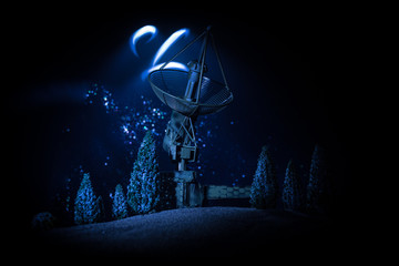 Silhouettes of satellite dishes or radio antennas against night sky. Space observatory.