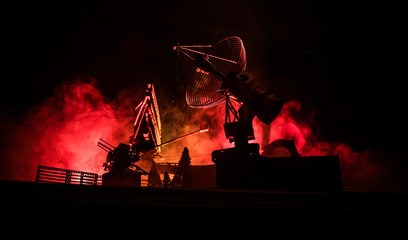 Silhouettes of satellite dishes or radio antennas against night sky. Space observatory.