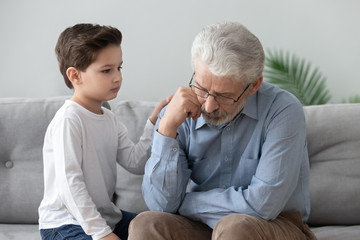 Little boy comfort upset grandfather showing support and love