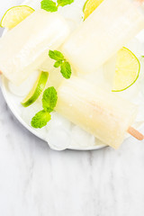 Fresh homemade lime popsicles with mint