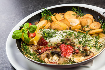 Grilled fish with fried potatoes, restaurant serving dish