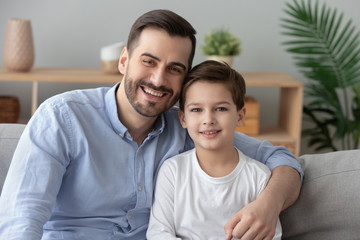 Portrait of happy young dad and son posing for picture