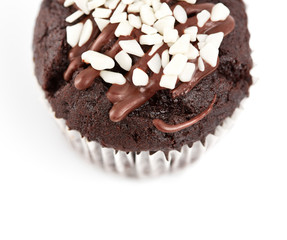 Tasty chocolate cupcakes on white background. Chocolate caramel cupcake and butterscotch syrup. Chocolate cupcake isolated on white.