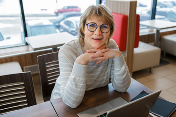 woman working on laptop in cafe, office