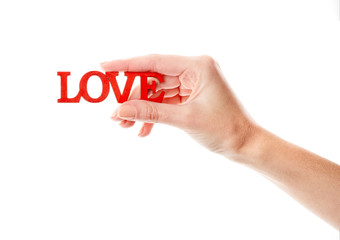 Female hand isolated on white background. White woman's hand showing symbols and gestures. Wooden red inscription love. Love