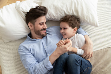 Happy father have fun playing with little son