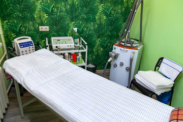 Cabinet cosmetology with a couch for massage, apparatus for vacuum massage lpg with green walls....