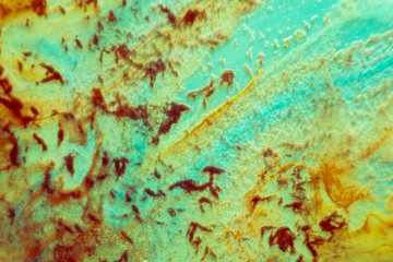 abstract texture. brown and aquamarine background. stains of watercolor paint in water