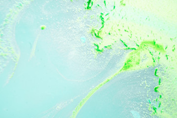 abstract texture. green paint background. stains of watercolor paint in water