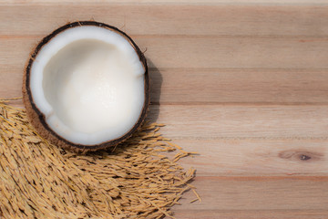 soft focus of coconut and rice on wooden surface, top view. 