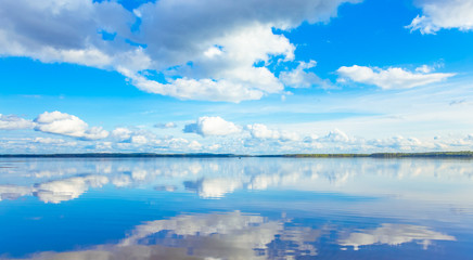 Summer lake landscape with fine reflections and dramatic sky. Sotkamo, Finland.
