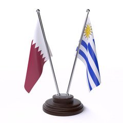 Qatar and Uruguay, two table flags isolated on white background. 3d image