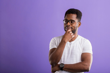 Dark skinned man isolated over purple background