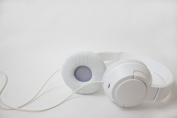 White headphones on a light background.