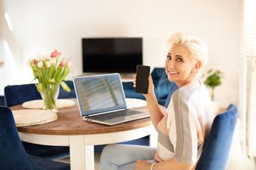 Attractive age woman working in home office.