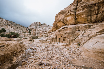 Caves in rocks in desert landscape of Petra, Jordan, Asia