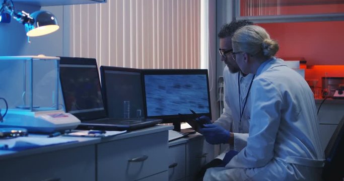 Scientists watching monitor and analyzing