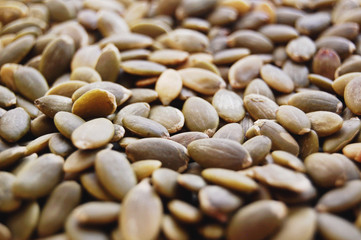 Raw pumpkin seeds background.