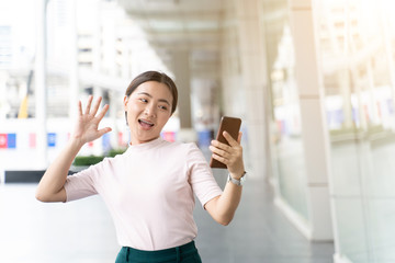 Happy asian woman taking a selfie in the city