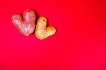 potatoes like a heart on red background