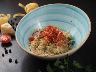 Spaghetti with cheese in a plate on the table