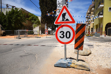 Roadwork and speed limit traffic signs in Yehud - small city in central Israel. 