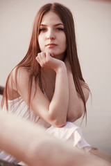 Naklejka premium young sad caucasian woman sitting alone outdoor